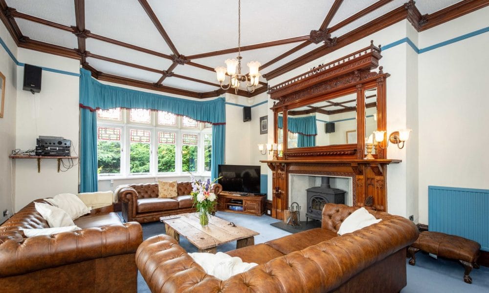 Leather Chesterfields, log burner and feature fire place at Fairlea Grange family and friends self catering accommodation www,bhhl.co.uk